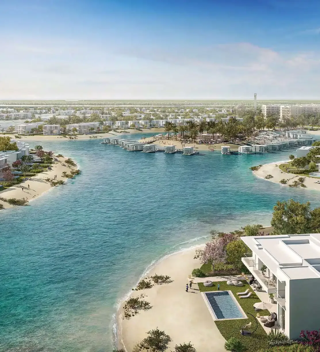 Beachside villas beside a turquoise lagoon.