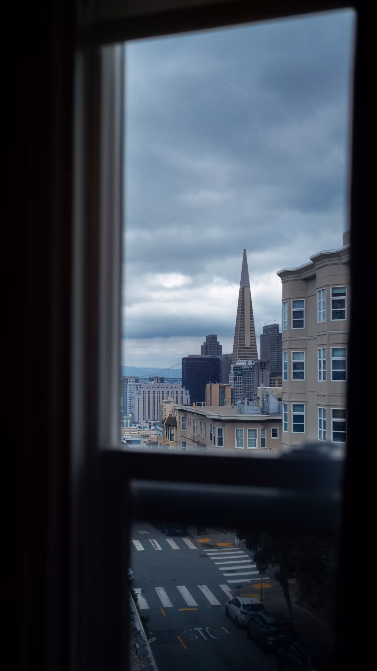 City skyline seen through an apartment window, representing property ownership managed from abroad
